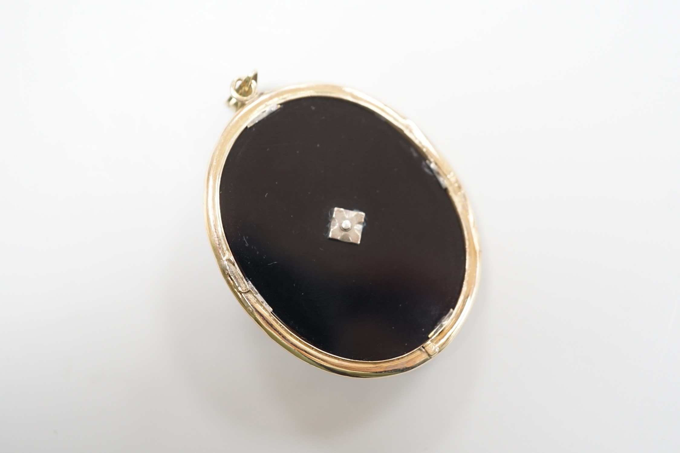 A Victorian yellow metal mounted, rose cut diamond set black onyx oval pendant, overall 56mm, gross weight 12.9 grams.